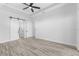 Spacious bedroom featuring tray ceilings, modern floors, and ample natural light at 24051 Pyramid Way, Punta Gorda, FL 33955