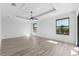 Spacious bedroom with tray ceiling, ceiling fan, wood flooring and ample natural light at 24051 Pyramid Way, Punta Gorda, FL 33955