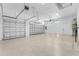 Spacious three car garage with epoxy flooring and modern lighting at 24051 Pyramid Way, Punta Gorda, FL 33955
