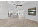 Open concept featuring an island kitchen with white cabinets and stainless appliances at 24051 Pyramid Way, Punta Gorda, FL 33955