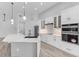Well-lit kitchen featuring white cabinets, stainless steel appliances and a marble countertop island at 24051 Pyramid Way, Punta Gorda, FL 33955