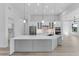 Modern kitchen features white cabinets, stainless steel appliances, and an island with marble countertop at 24051 Pyramid Way, Punta Gorda, FL 33955