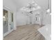 Spacious living room with elegant light wood floors, tray ceiling detail, and recessed lighting at 24051 Pyramid Way, Punta Gorda, FL 33955
