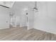 Minimalist room with light wood flooring and white walls leads to additional rooms at 24051 Pyramid Way, Punta Gorda, FL 33955