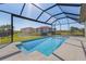 Inviting screened-in pool overlooking a serene pond and lush landscaping, perfect for relaxation and entertainment at 24051 Pyramid Way, Punta Gorda, FL 33955