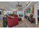 Spacious living room featuring wood floors, neutral walls, ceiling fan and views of the backyard at 3906 Crooked Island Dr, Punta Gorda, FL 33950