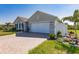 Charming home with a paved driveway, two-car garage, and well-maintained landscaping at 27261 Guapore Dr, Punta Gorda, FL 33983