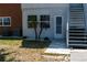 View of the building's exterior featuring an entrance with stairs and landscaping with young palm trees at 4158 Tamiami Trl # U6, Port Charlotte, FL 33952