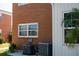 Brick and siding exterior with modern HVAC units and neatly kept landscaping near the building's windows at 4158 Tamiami Trl # U6, Port Charlotte, FL 33952