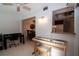 Home office features a desk, piano, and view of the kitchen at 4158 Tamiami Trl # U6, Port Charlotte, FL 33952