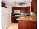 Modern kitchen with wood cabinets, built in microwave, and tile floor at 4158 Tamiami Trl # U6, Port Charlotte, FL 33952