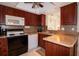 Well-equipped kitchen with wood cabinets, modern appliances, and tile flooring at 4158 Tamiami Trl # U6, Port Charlotte, FL 33952