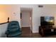 Cozy living room featuring a recliner, TV, and access to hallway at 4158 Tamiami Trl # U6, Port Charlotte, FL 33952