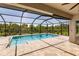 Inviting pool and patio area with screened enclosure, providing a relaxing outdoor space at 27261 Guapore Dr, Punta Gorda, FL 33983