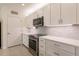 Modern kitchen with white cabinets, stainless steel appliances and backsplash at 27261 Guapore Dr, Punta Gorda, FL 33983