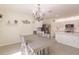 Dining room features a chandelier and gray table with six chairs at 27261 Guapore Dr, Punta Gorda, FL 33983