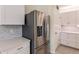 Stainless steel refrigerator in a kitchen with white shaker cabinets at 27261 Guapore Dr, Punta Gorda, FL 33983