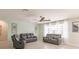 Bright living room featuring gray reclining sofas and tile flooring at 27261 Guapore Dr, Punta Gorda, FL 33983