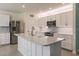 Modern kitchen with white cabinets, stainless steel appliances, and an island at 27261 Guapore Dr, Punta Gorda, FL 33983