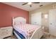 Bedroom with flamingo bedding and ceiling fan at 27261 Guapore Dr, Punta Gorda, FL 33983