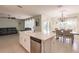 Open kitchen with island, stainless steel appliances, and view of living room at 27261 Guapore Dr, Punta Gorda, FL 33983