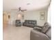 Living room with gray reclining sofas and tile flooring at 27261 Guapore Dr, Punta Gorda, FL 33983