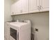 Laundry room with white cabinets and matching washer and dryer at 27261 Guapore Dr, Punta Gorda, FL 33983