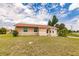 Front view of a single-story house with a lawn and driveway at 600 Beeche Nw Ter, Port Charlotte, FL 33948