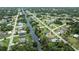 Scenic aerial shot of a charming waterfront neighborhood with lush green landscaping at 2256 Auburn Blvd, Port Charlotte, FL 33948