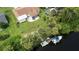 An aerial view of a home with a private boat dock and access to a waterway at 2256 Auburn Blvd, Port Charlotte, FL 33948