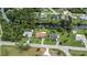 Beautiful aerial view of a home with mature trees and a waterfront canal at 2256 Auburn Blvd, Port Charlotte, FL 33948