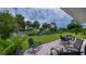 Outdoor patio with furniture and a view of the waterfront and palm trees creating a tropical oasis at 2256 Auburn Blvd, Port Charlotte, FL 33948