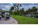 Lush backyard with manicured lawn, patio, and access to the water at 2256 Auburn Blvd, Port Charlotte, FL 33948