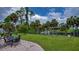 Landscaped backyard with patio, lawn, and canal view create a private outdoor space at 2256 Auburn Blvd, Port Charlotte, FL 33948