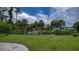 Spacious backyard with lush green grass, privacy fence, and waterfront views at 2256 Auburn Blvd, Port Charlotte, FL 33948