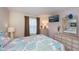 Comfortable bedroom featuring a large window, neutral-toned walls, flat screen TV, and coastal-themed decor accents at 2256 Auburn Blvd, Port Charlotte, FL 33948