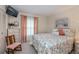 Comfortable bedroom featuring a large window, neutral-toned walls, and floral themed decor accents at 2256 Auburn Blvd, Port Charlotte, FL 33948