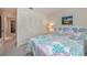 Bright bedroom featuring a large window, closet, neutral-toned walls, and coastal-themed decor accents at 2256 Auburn Blvd, Port Charlotte, FL 33948