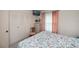 Comfortable bedroom featuring a TV, closet, and soothing pink accents at 2256 Auburn Blvd, Port Charlotte, FL 33948