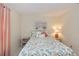 Bright bedroom featuring a large window, neutral-toned walls, and floral themed decor accents at 2256 Auburn Blvd, Port Charlotte, FL 33948