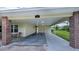 Covered car port with brick columns, ample parking, and access to the home at 2256 Auburn Blvd, Port Charlotte, FL 33948