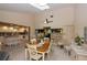 Open-concept dining area with views to a modern kitchen and living area for entertaining at 2256 Auburn Blvd, Port Charlotte, FL 33948