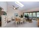 Open dining room with abundant natural light, a ceiling fan and views into the living room at 2256 Auburn Blvd, Port Charlotte, FL 33948