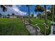Dock leading to the water with a well-maintained lawn and fenced backyard at 2256 Auburn Blvd, Port Charlotte, FL 33948