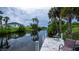 Picturesque view of a private dock on a calm canal, perfect for relaxing outdoors at 2256 Auburn Blvd, Port Charlotte, FL 33948