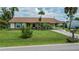 Charming single-story home featuring a brick-accented facade, manicured lawn, and a covered carport at 2256 Auburn Blvd, Port Charlotte, FL 33948