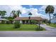 Charming single-story home featuring a brick-accented facade, manicured lawn, and a covered carport at 2256 Auburn Blvd, Port Charlotte, FL 33948