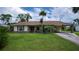Charming single-story home featuring well-maintained lawn and cozy front porch area at 2256 Auburn Blvd, Port Charlotte, FL 33948