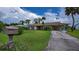 Charming single-story home with brick details, well-maintained lawn, and a covered carport at 2256 Auburn Blvd, Port Charlotte, FL 33948