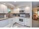 Clean kitchen featuring white cabinets, granite countertops, and modern appliances at 2256 Auburn Blvd, Port Charlotte, FL 33948